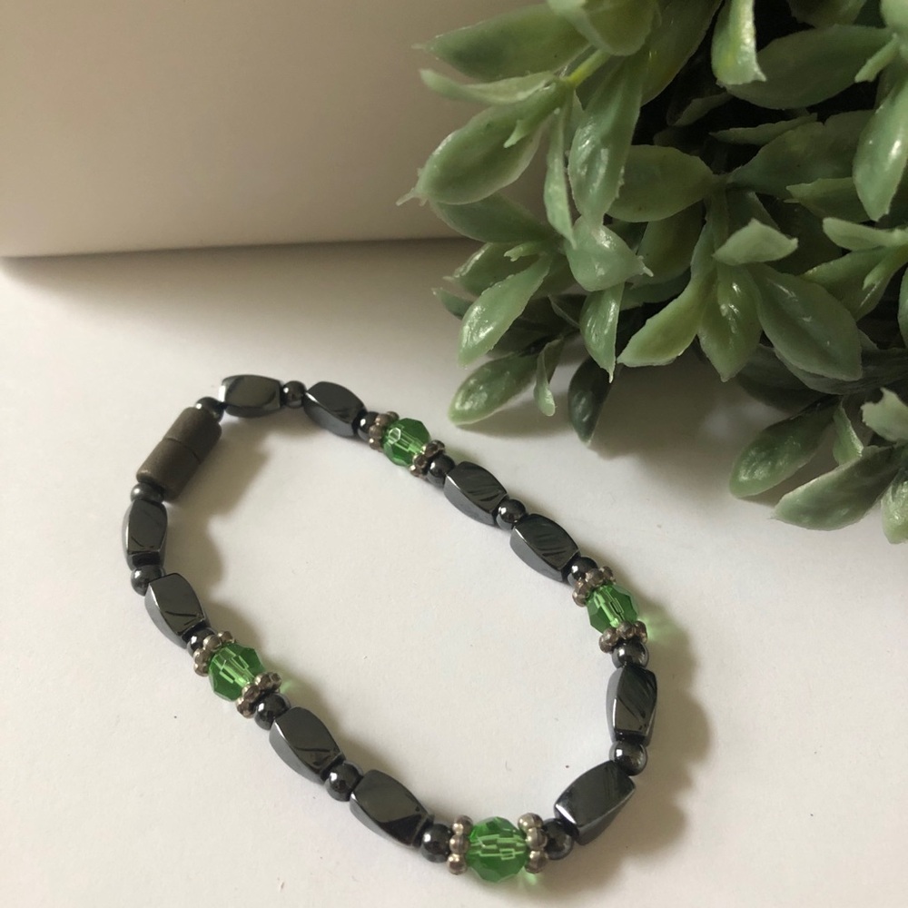 Magnetic hematite bracelet accented with green crystal beads.